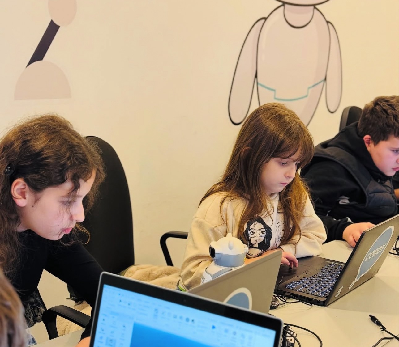 Coddy students working on laptops in class